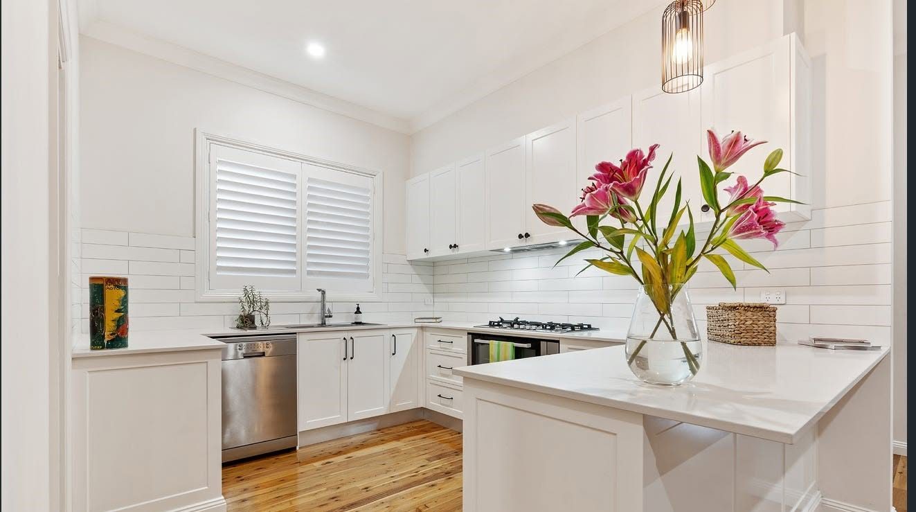 Renovated kitchen with stone benchtops and shaker cabinetry