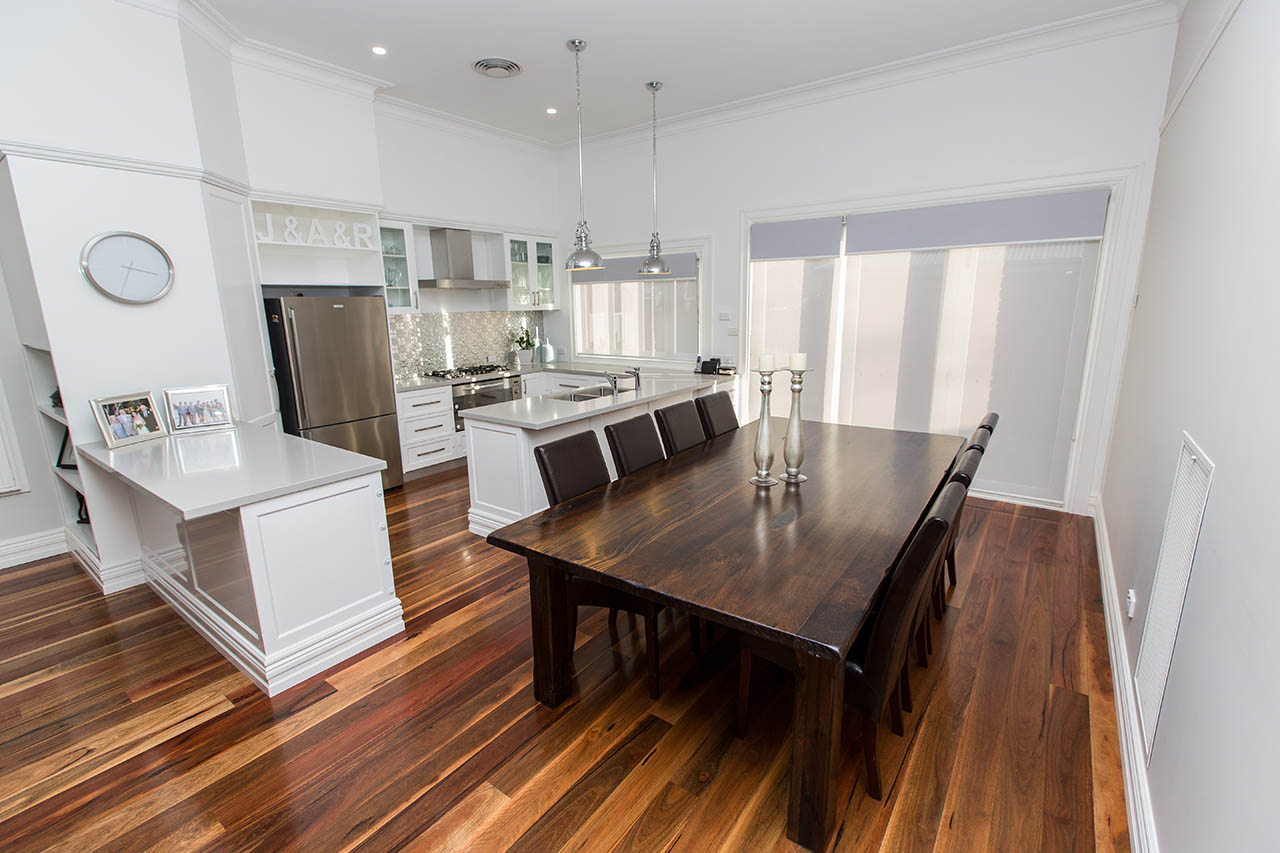 Renovated open plan dining area with polished timber floors and joinery