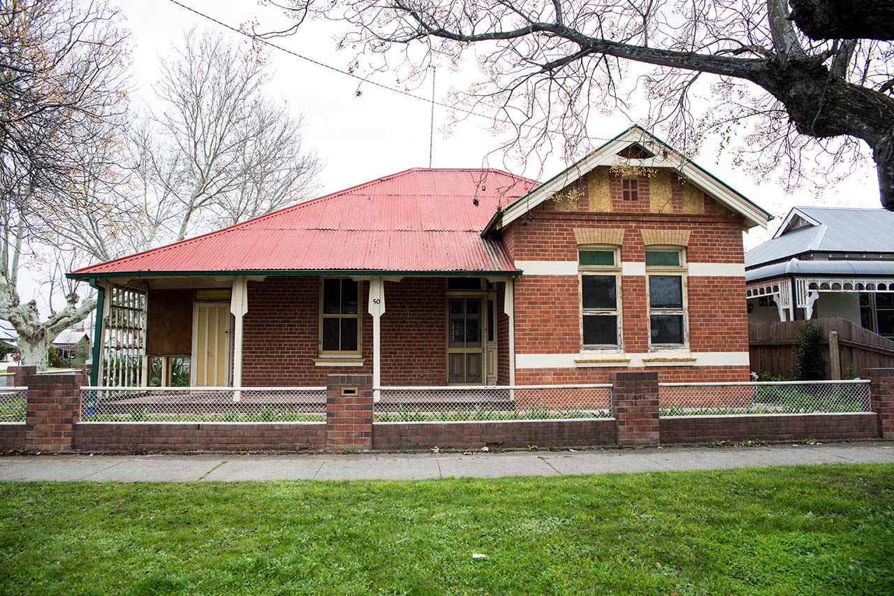 Brick cottage in Wagga Wagga before renovation, seen from the street with its original red roof