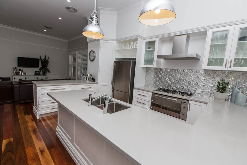 Renovated kitchen with stone island bench, gas cooktop and timber floors